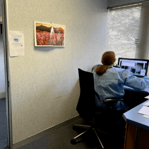 One of the Headache Clinic's diagnostic radiographers studying a set of patient's Xrays who suffers from myofascial pain.