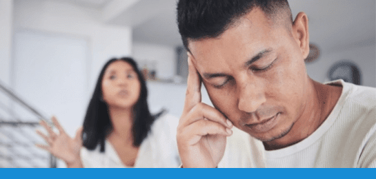 A couple arguing while a man is holding his head due to a migraine episode