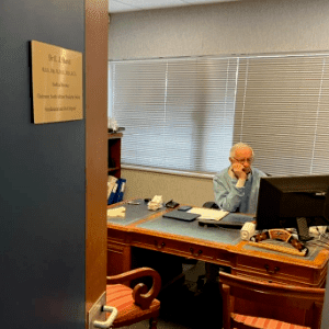 Dr Elliot Shevel at his desk preparing for his next patient who suffers from trigeminal neuralgia.